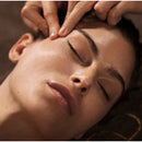 visage de femme, les yeux fermés en train de se faire masser les tempes