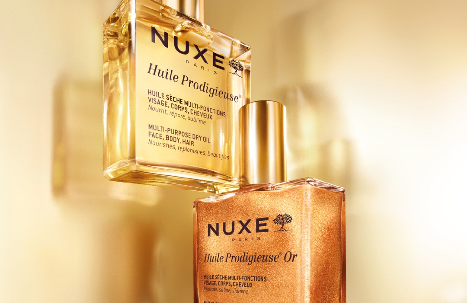 Sur l’image, on retrouve deux produits emblématiques de la marque de cosmétiques Nuxe : l’Huile Prodigieuse, véritable icône de la marque, ainsi que l’Huile Prodigieuse Or. Il s’agit de deux huiles sèches multifonctions.